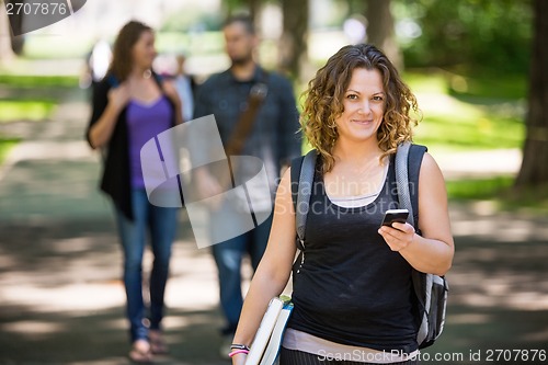 Image of Female Student Using Cellphone On Campus