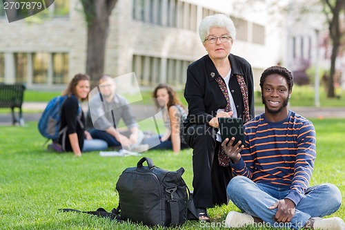Image of Professor Helping Student on Digital Tablet