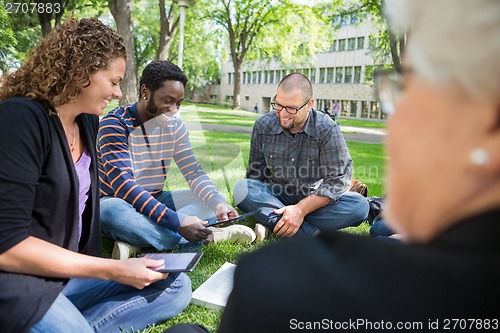 Image of Group Of Students Using Digital Tablet On Campus