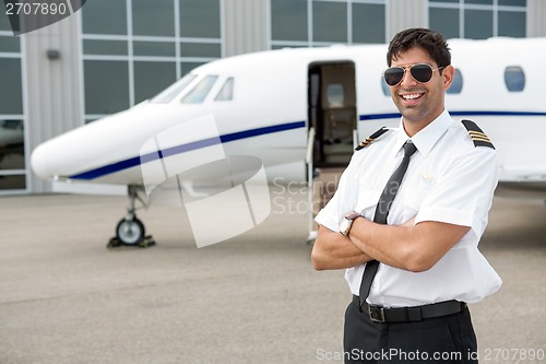 Image of Smiling Pilot Standing In Front Of Private Jet