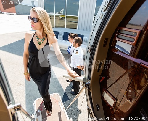 Image of Beautiful Woman In Dress Boarding Private Jet