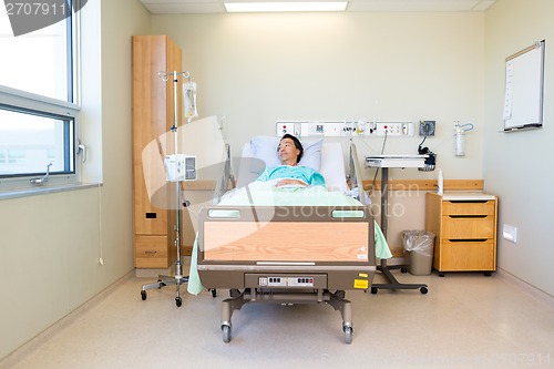 Image of Patient Lying On Bed While Looking At Window In Hospital