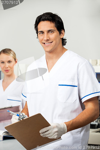 Image of Male Researcher Holding Clipboard In Lab