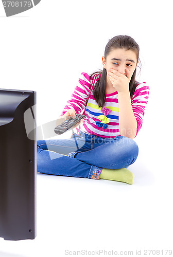 Image of Scared  little girl watching tv