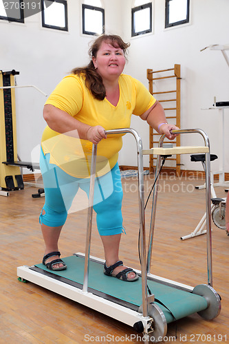 Image of overweight woman running on trainer treadmill