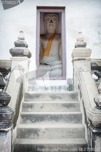 Image of Buddha sits a small room. Thailand, Ayutthaya