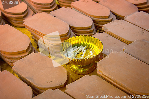 Image of Clay tiles and chalk. On tiling people write names