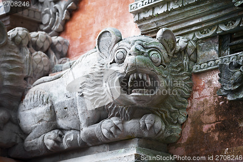 Image of Animal like a dog on the wall of temple. Bali, Indonesia