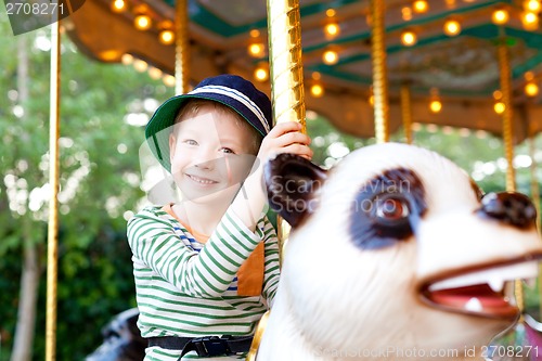 Image of kid at the merry-go-round