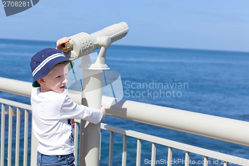 Image of boy using seaside binoculars