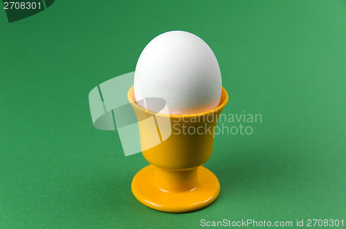 Image of Egg in cup at green background