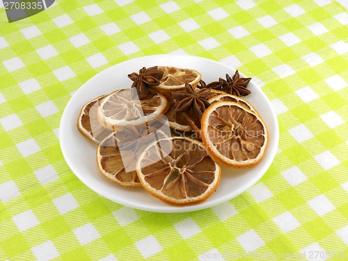 Image of old lemon slices and cinnamon on white plate