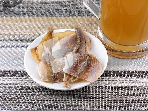 Image of smoked fish and cup of beer on a background