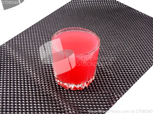 Image of fresh cherry juice in a glass on black background