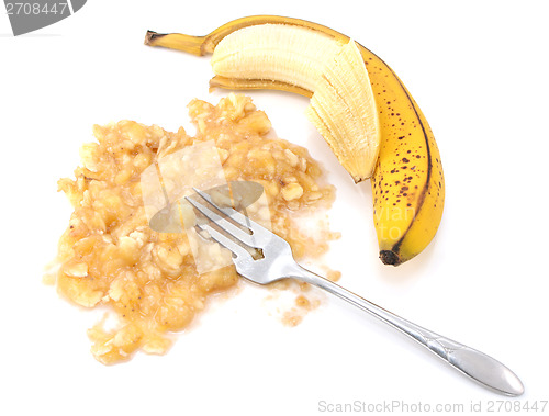 Image of Half-peeled ripe banana with mashed fruit