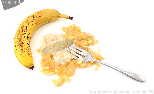 Image of Overripe unpeeled banana with fork and pureed fruit