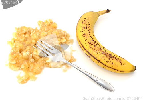 Image of Spotty ripe banana with mashed flesh and fork