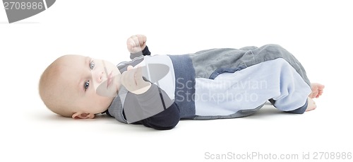 Image of smiling toddler laying on his back