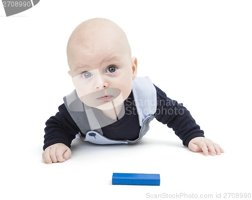 Image of interested baby with toy block