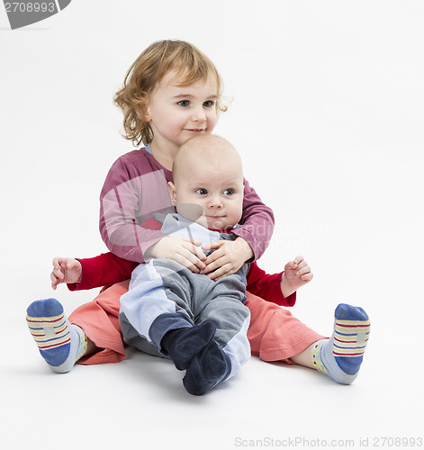 Image of siblings isolated in light background