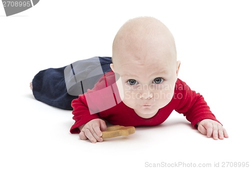 Image of toddler with toy and red shirt crawling
