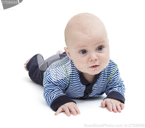 Image of attentive baby laying on ground
