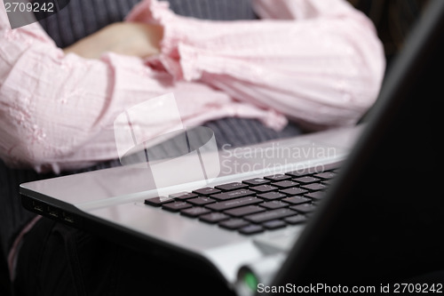 Image of Young woman working on laptop