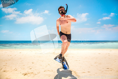 Image of Funny man jumping in flippers and mask.