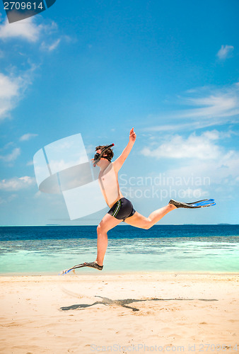 Image of Funny man jumping in flippers and mask.