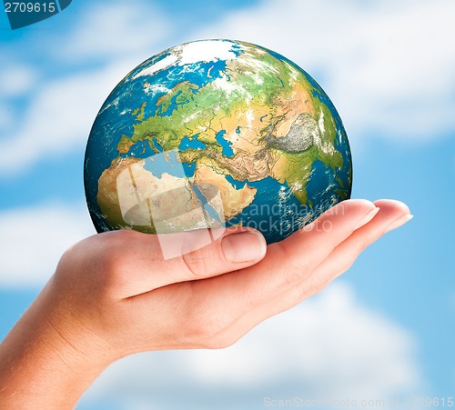 Image of Hand of the person holds globe.