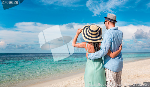 Image of Vacation Couple walking on tropical beach Maldives.