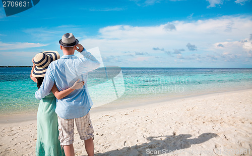 Image of Vacation Couple walking on tropical beach Maldives.