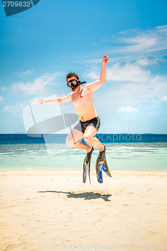 Image of Funny man jumping in flippers and mask.