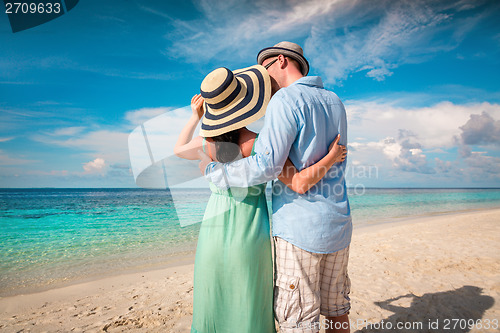 Image of Vacation Couple walking on tropical beach Maldives.