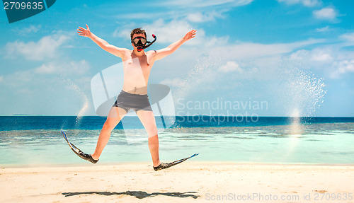 Image of Funny man jumping in flippers and mask.