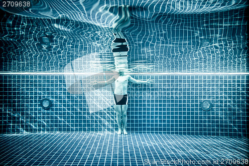 Image of Persons standing under water in a swimming pool