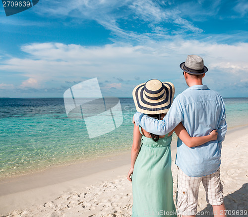 Image of Vacation Couple walking on tropical beach Maldives.