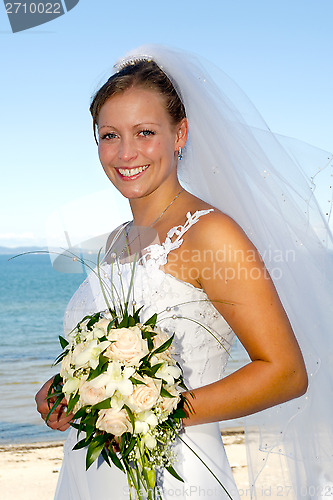 Image of Happy smiling wedding bride with bouquet.