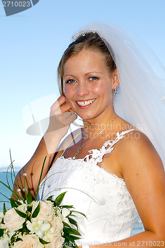 Image of Happy smiling wedding bride with bouquet.