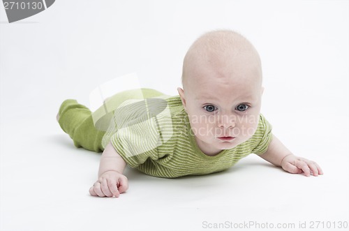 Image of pensive toddler in green clothing