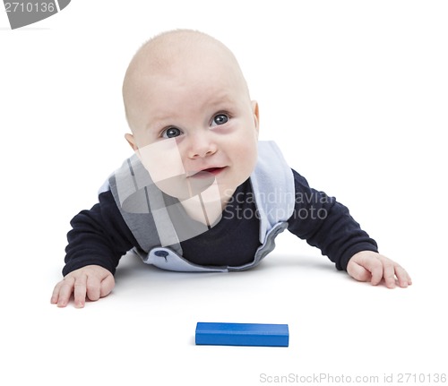 Image of interested baby with toy block