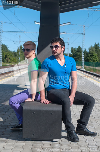 Image of Handsome guys sitting on platform