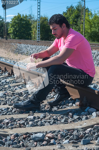 Image of One man in pink on train tracks