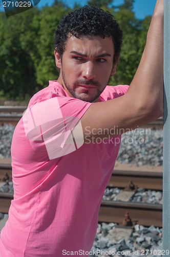 Image of Handsome young guy in pink t-shirt