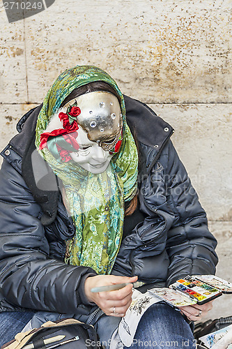 Image of Woman Painting Masks