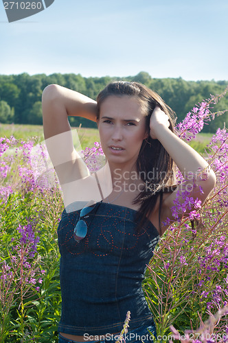 Image of Beautiful brunette female in field