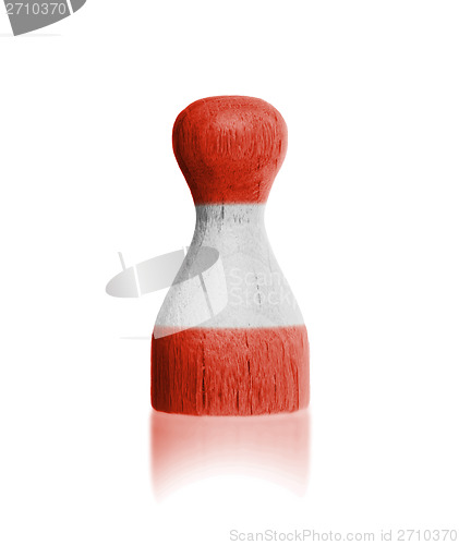 Image of Wooden pawn with a painting of a flag