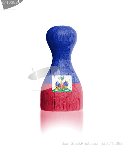 Image of Wooden pawn with a painting of a flag