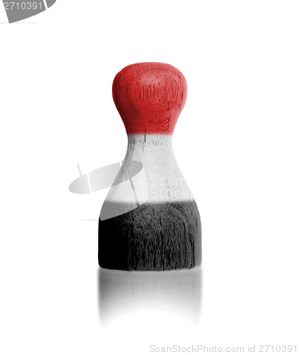 Image of Wooden pawn with a painting of a flag