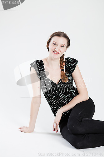 Image of Happy attractive woman sitting